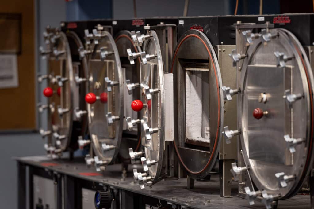 A row of specialized high-temperature laboratory furnaces used for thermal processing, calcination, and advanced material scale-up.