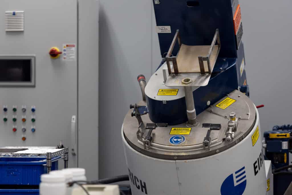 A large industrial intensive mixer in a clean manufacturing facility, utilized for high-capacity powder blending, granulation, and advanced material formulation.